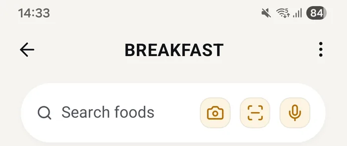 Real app screen: the top of a meal screen, the search bar with the camera, barcode and microphone buttons